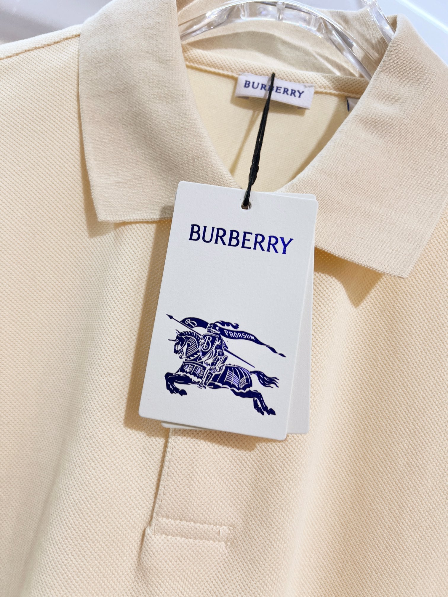 Burberry short-sleeve polo shirt in light cream, neckline fabric with hanging tag