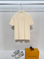 Burberry short-sleeve polo shirt in light cream, back view on a hanger