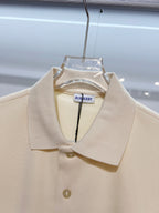 Burberry short-sleeve polo shirt in light cream, close-up of collar and front buttons