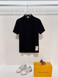 Black short-sleeve polo shirt with ribbed collar and button placket, Burberry label