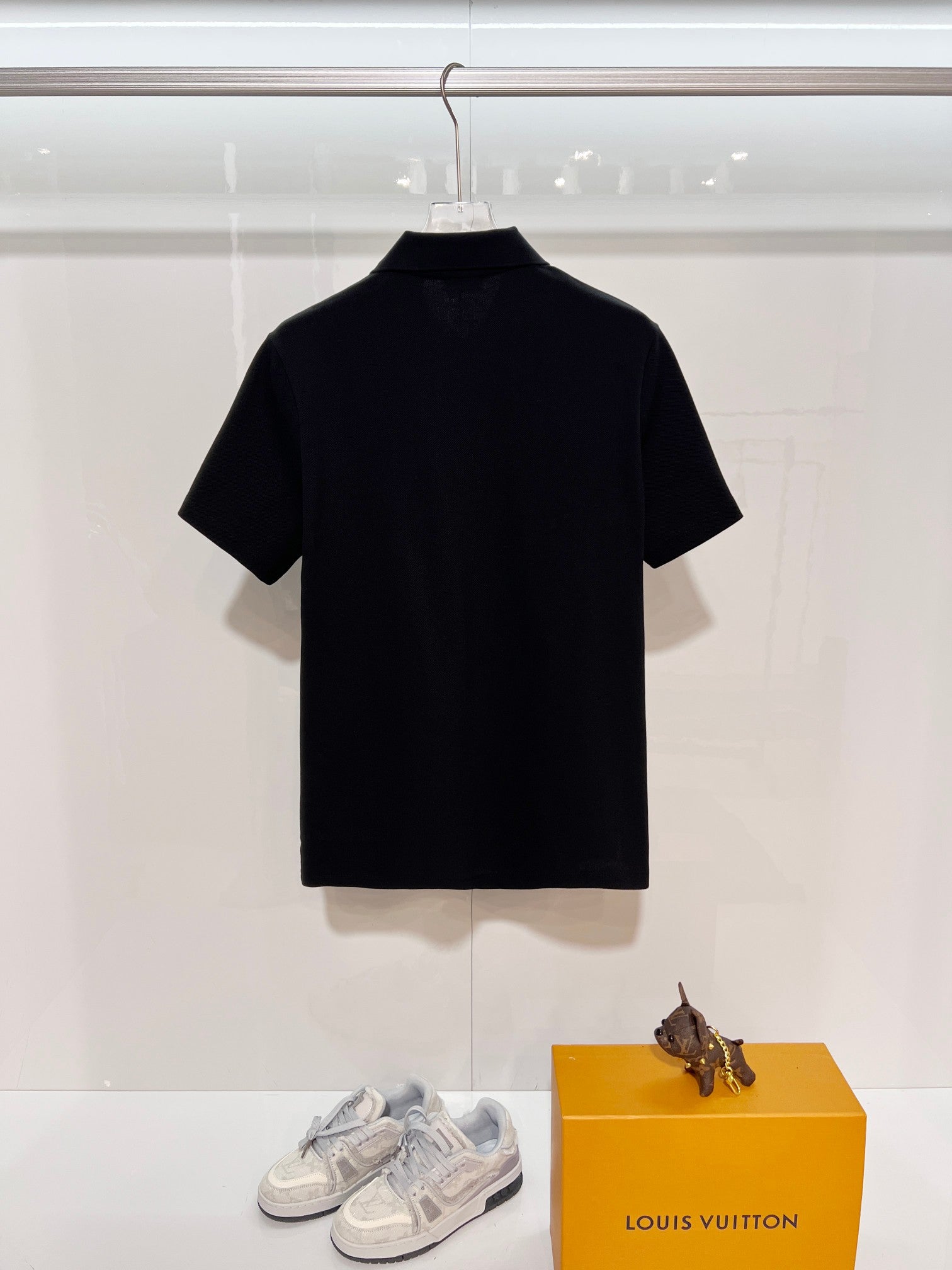 Black short-sleeve polo shirt on hanger, stand collar detail, Burberry label