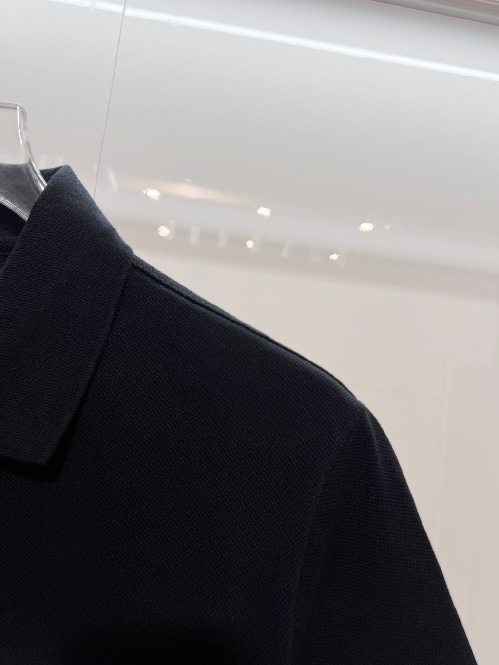 Black polo collar and shoulder detail