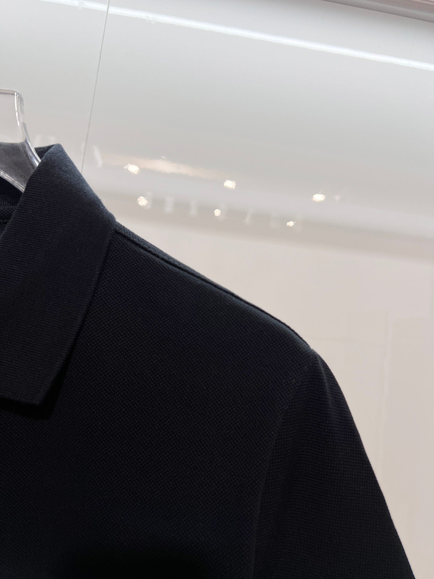 Black polo collar and shoulder detail