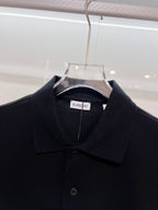 Black polo shirt close-up with Burberry neck label and button placket