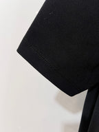 Black textured polo sleeve end with stitched hem
