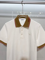 Burberry short-sleeve polo shirt in white with brown fold-over collar and buttons