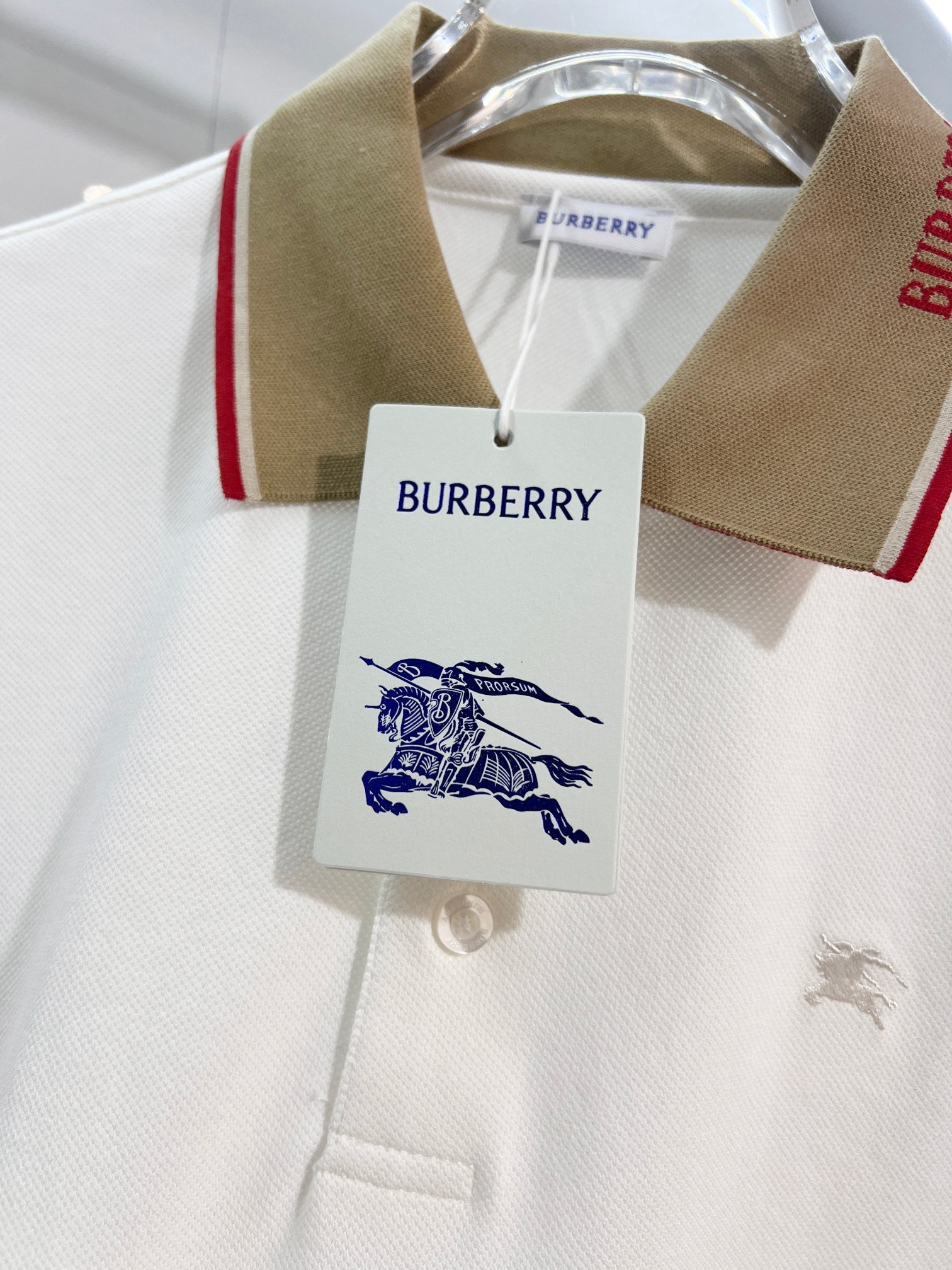 Burberry polo shirt collar close-up with brand logo patch and white button placket
