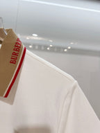 Burberry polo shirt shoulder close-up with brown collar panel and red stripe