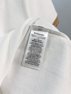 Burberry polo shirt care label inside collar area on white fabric
