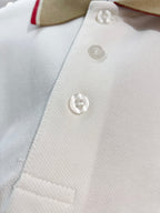 Burberry polo shirt button placket close-up with three white buttons