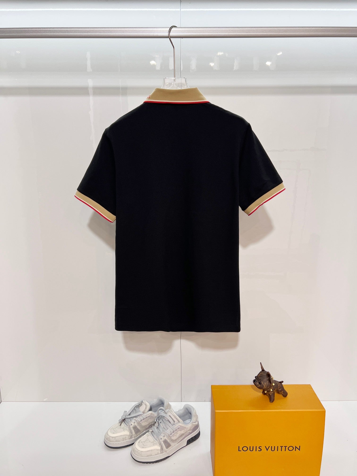 Burberry polo shirt in dark navy, back view with beige and red striped collar edge