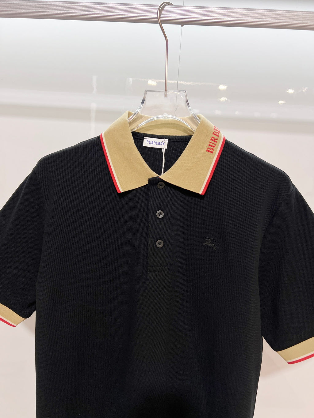 Burberry polo shirt in dark navy with beige pointed collar and buttoned placket