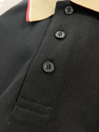 Burberry polo shirt chest close-up with dark navy textured fabric and black buttons