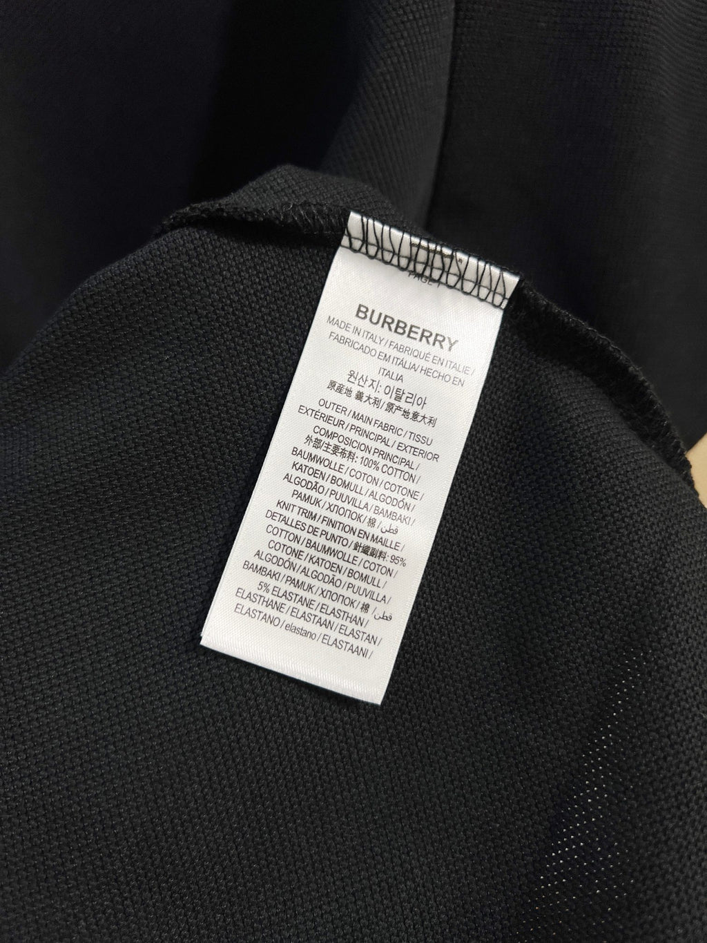 Burberry polo shirt care label on dark navy inner collar