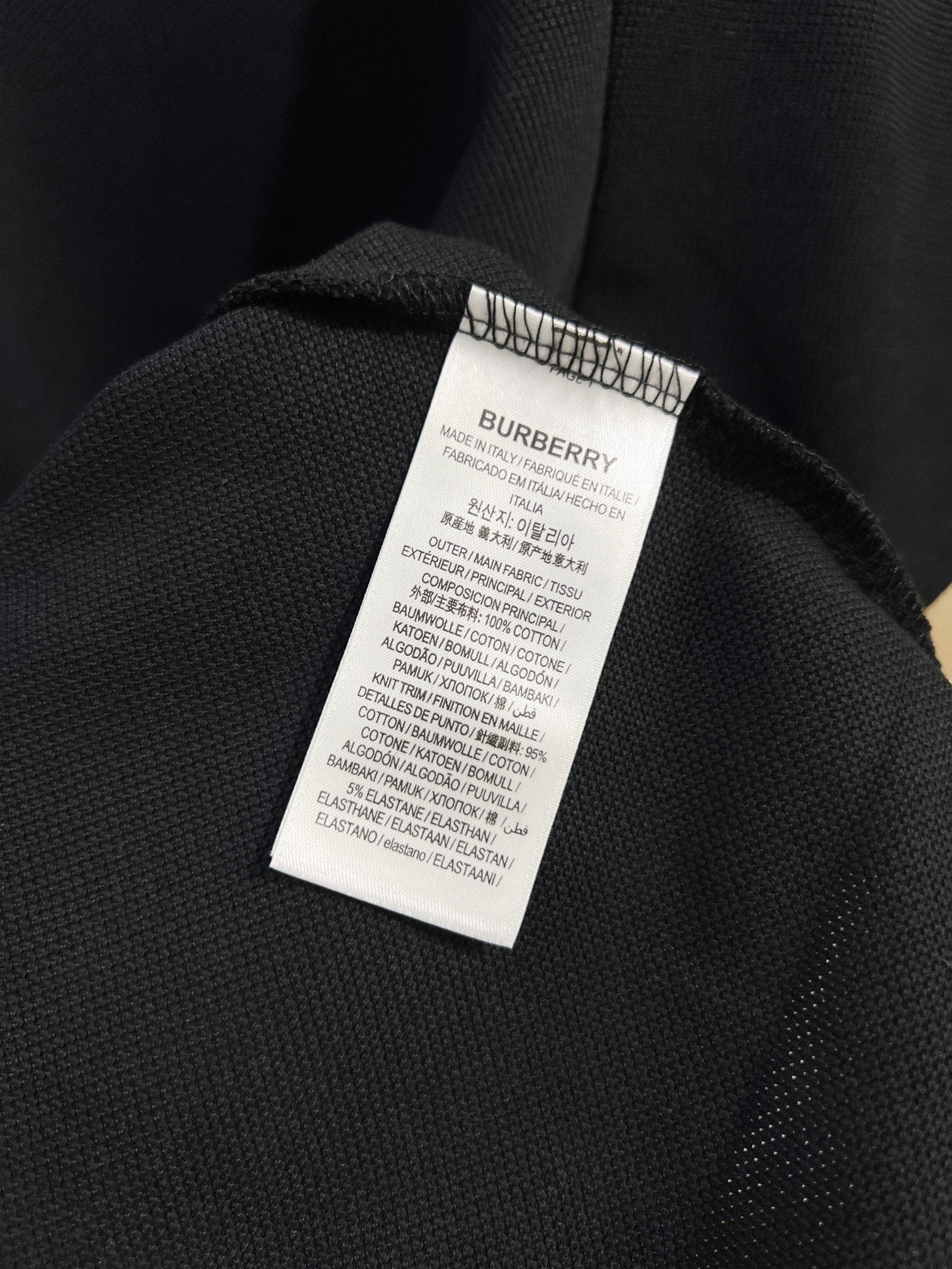 Burberry polo shirt care label on dark navy inner collar