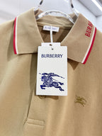 Tan polo shirt close-up of collar tag, red trim, and small horse logo