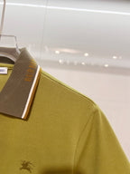 Olive green polo sleeve with embroidered horse logo and contrast collar edge