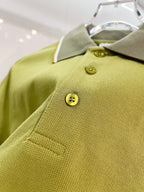 Olive green polo front with two-button placket and embroidered logo on chest