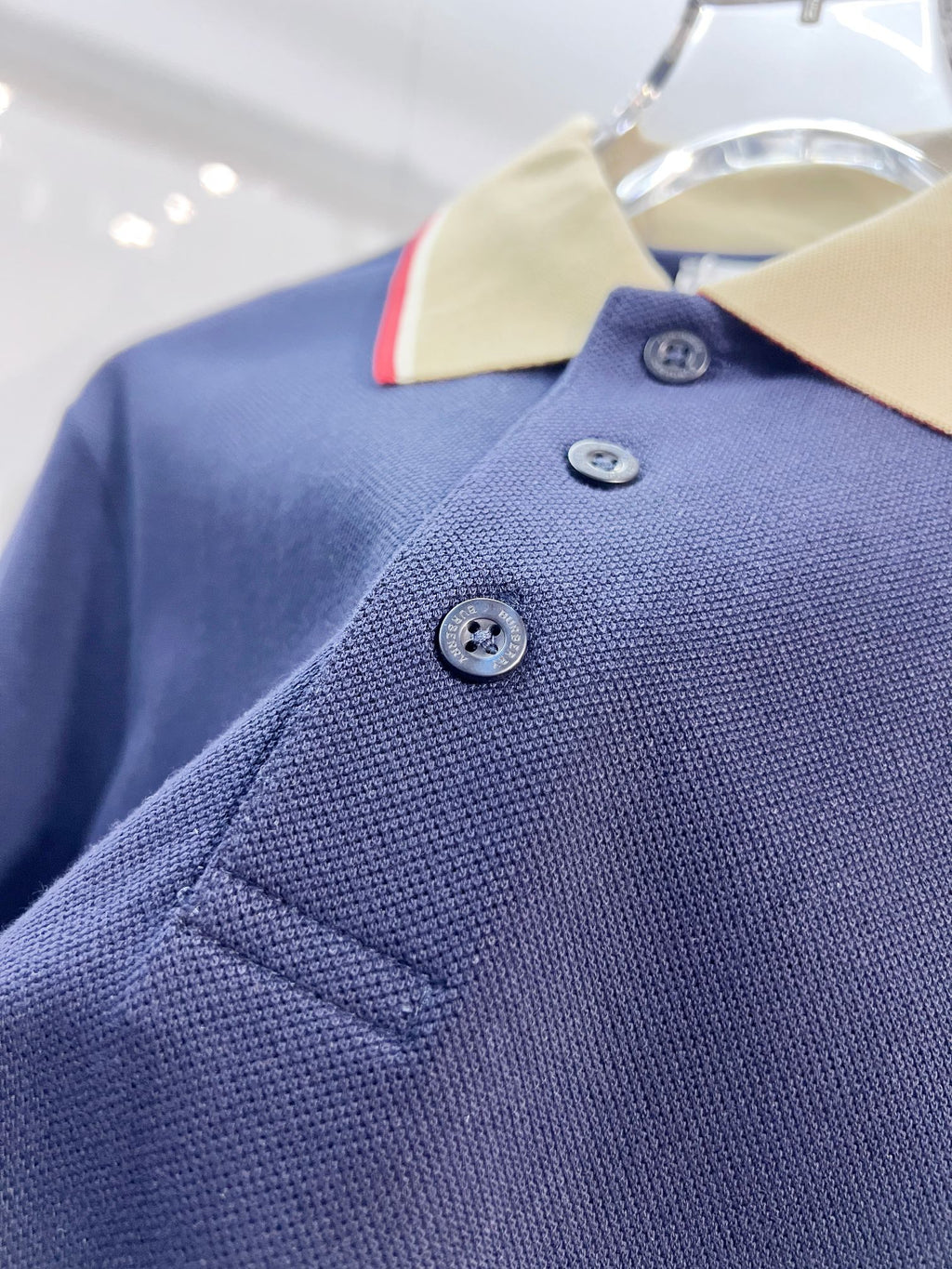 Dark blue Burberry polo shirt with three buttons and stitched placket detail