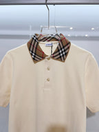 Cream short-sleeve polo shirt with Burberry check collar and gold buttons