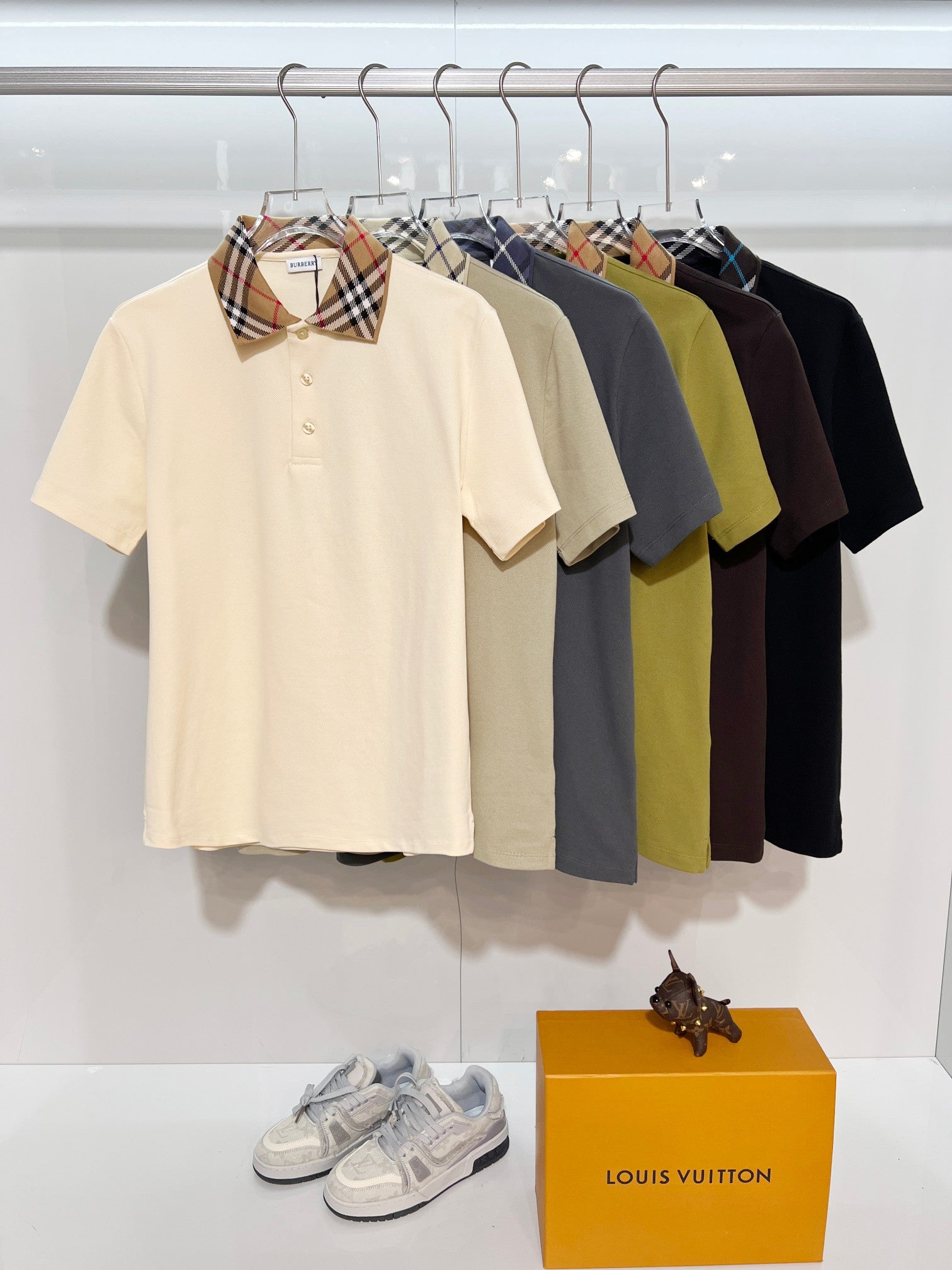 Short-sleeve polos on display: cream, navy, black, gray, and green with check collars