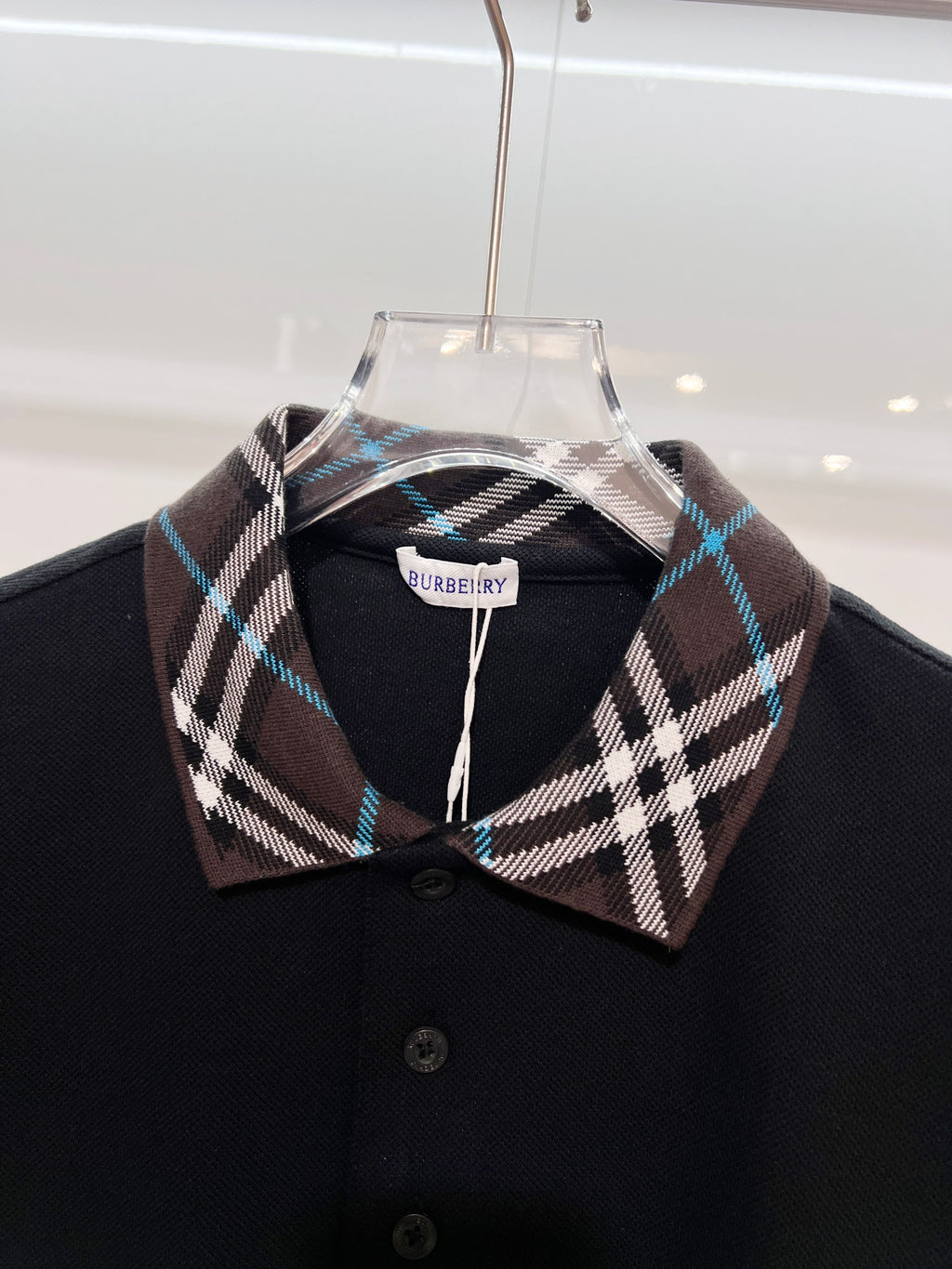 Black polo shirt with Burberry plaid collar and front button placket