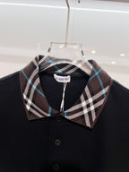Black polo shirt with Burberry plaid collar and front button placket