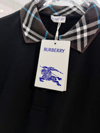 Black polo shirt with Burberry plaid collar and white hang tag