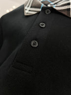 Black polo shirt front with three buttons and Burberry plaid collar