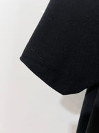 Black polo shirt sleeve with textured fabric and cuff edge