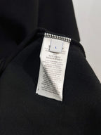Black polo shirt with interior fabric label near collar