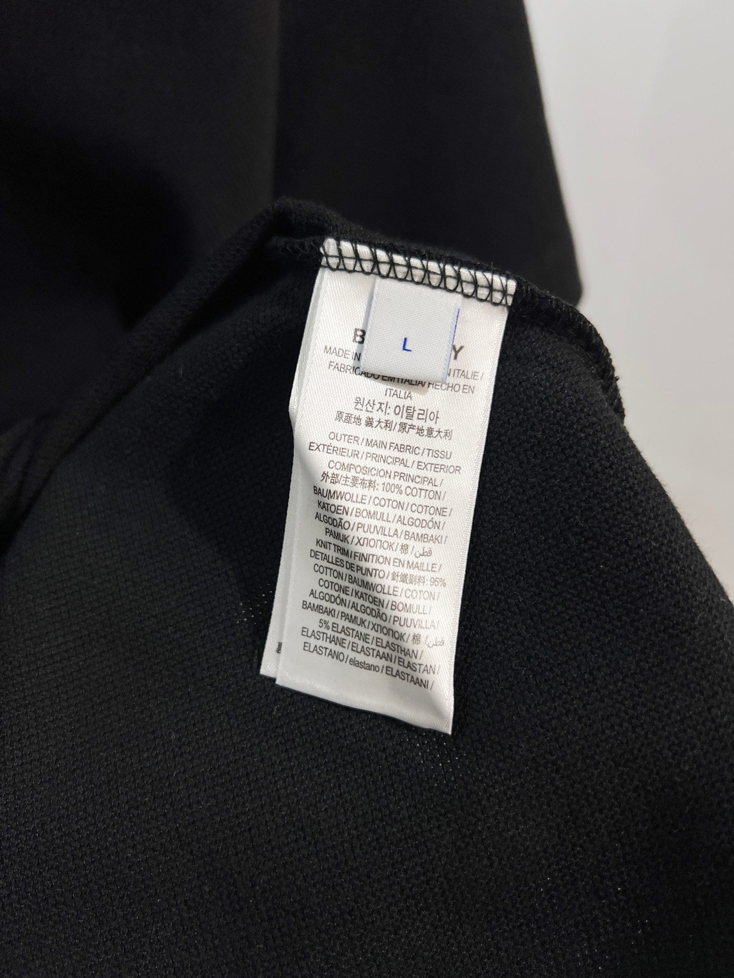 Black polo shirt with interior fabric label near collar
