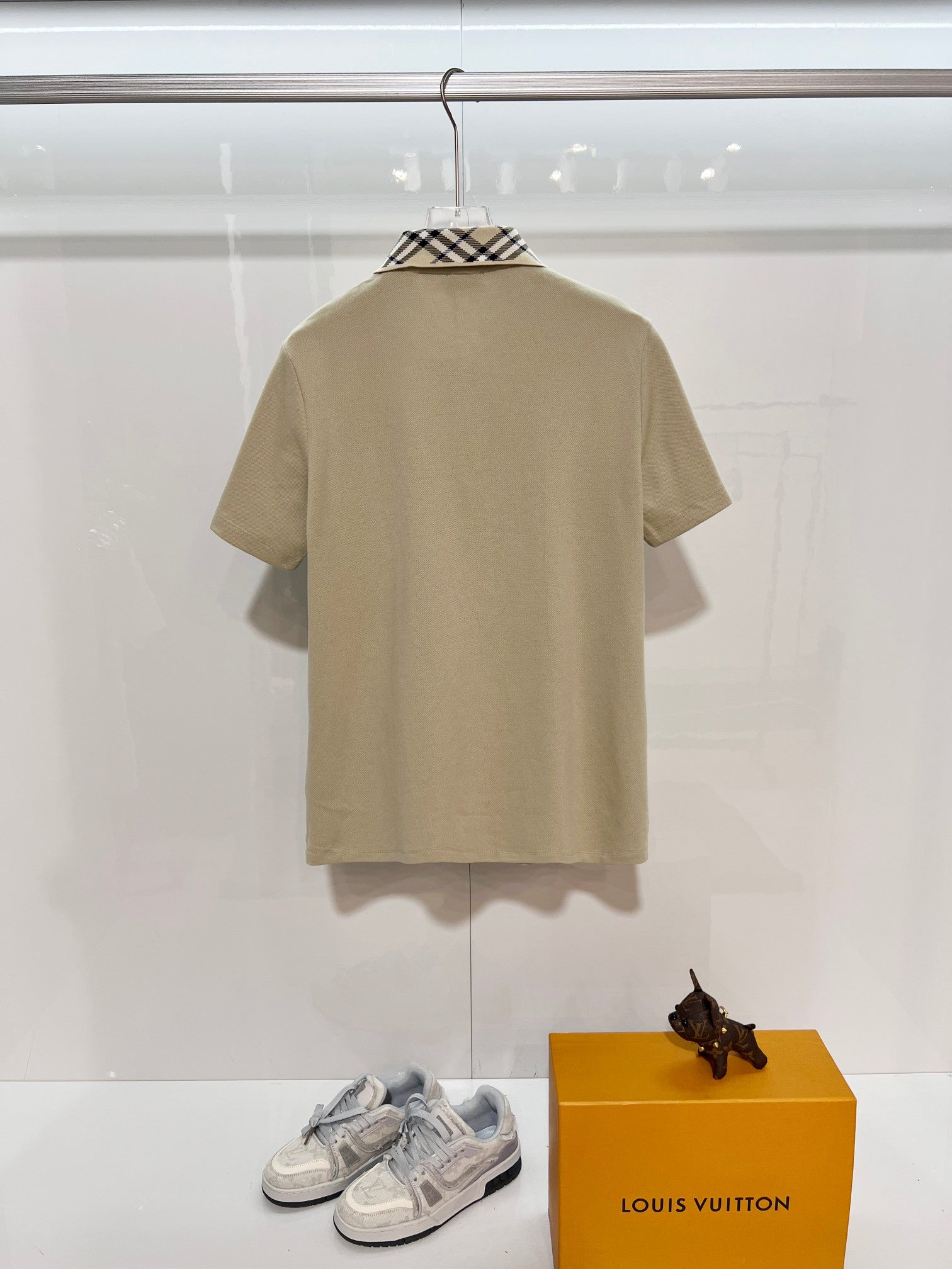 Beige short-sleeve polo shirt on hanger, plain back