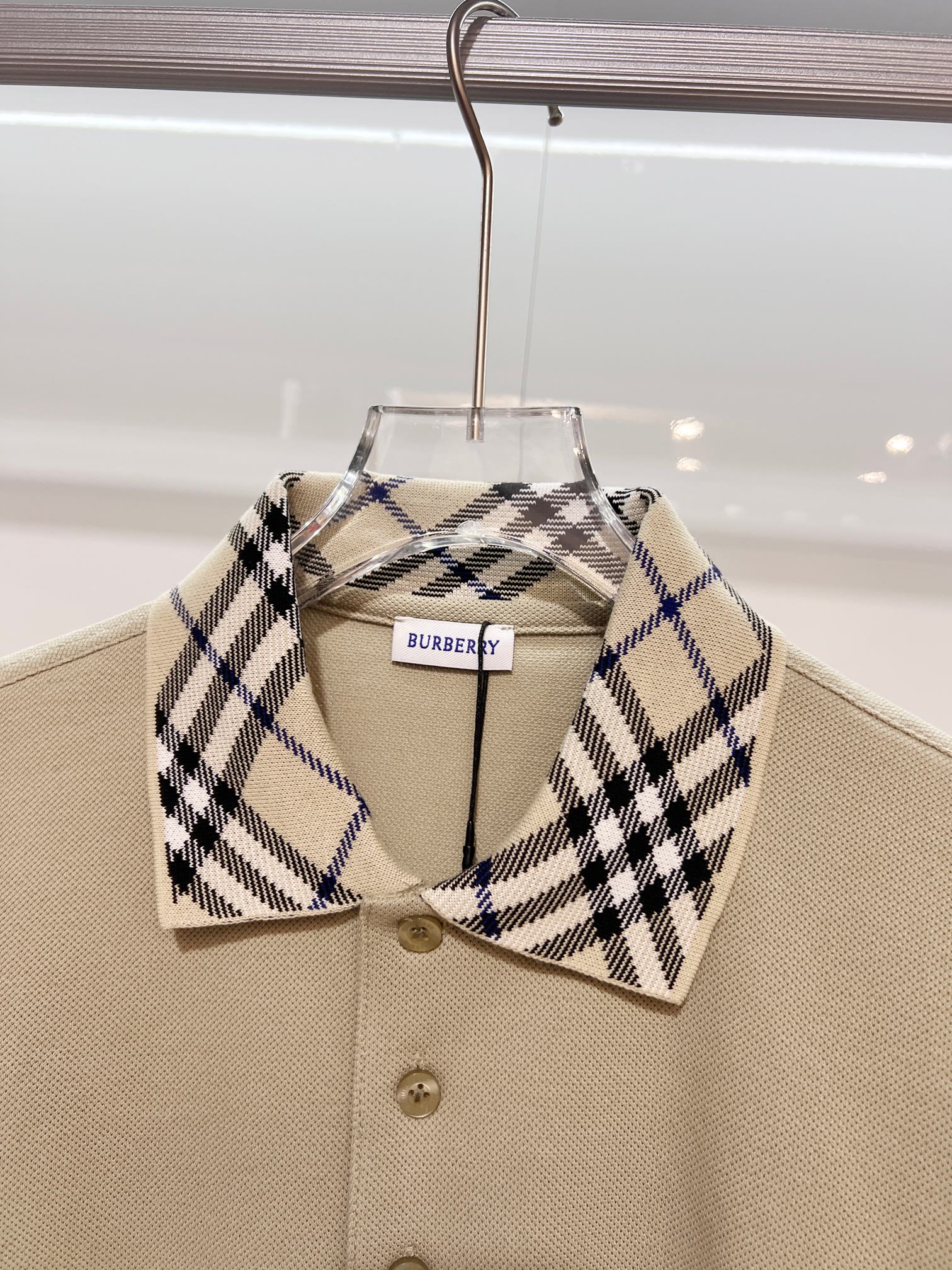 Beige polo shirt with checkered spread collar and button placket