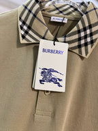 Beige polo shirt with Burberry checkered inner collar and brand hang tag