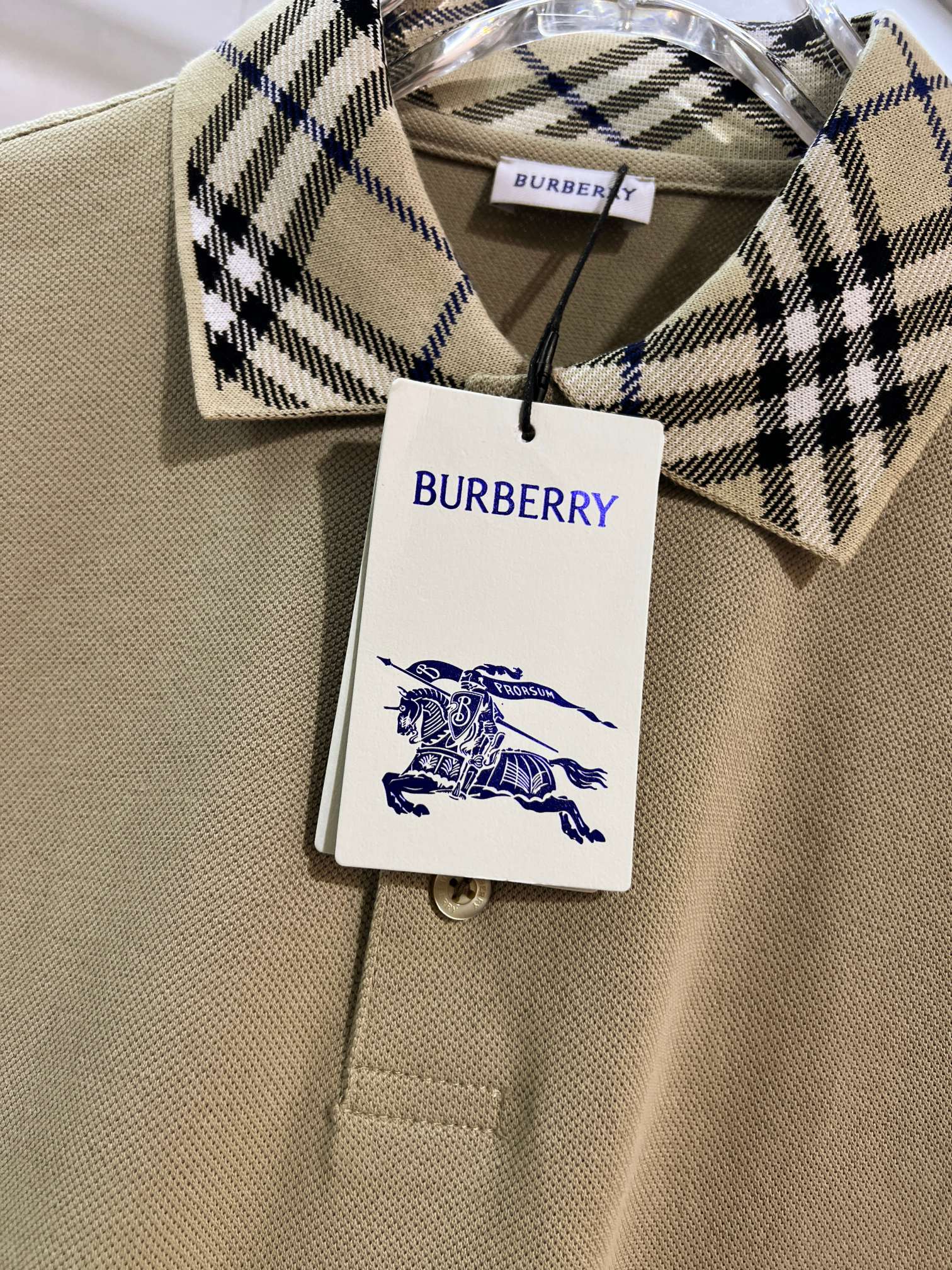 Beige polo shirt with Burberry checkered inner collar and brand hang tag