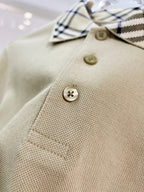 Beige polo shirt with gold buttons and checkered collar