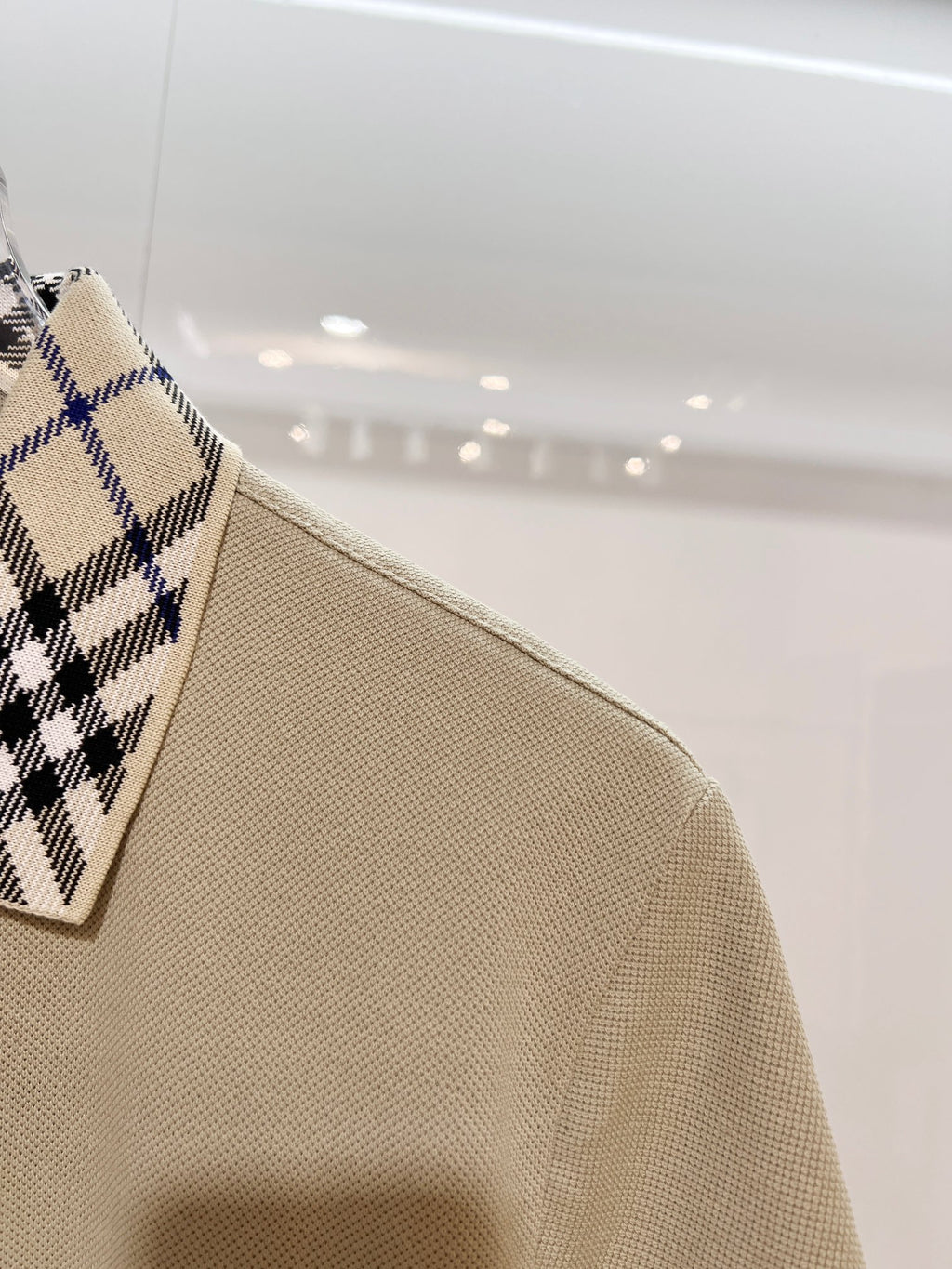 Beige polo shirt sleeve and shoulder, textured weave