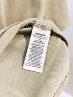 Beige polo shirt with Burberry care label inside collar