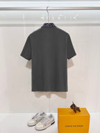 Mens short-sleeve polo shirt in dark gray, back view on display hanger
