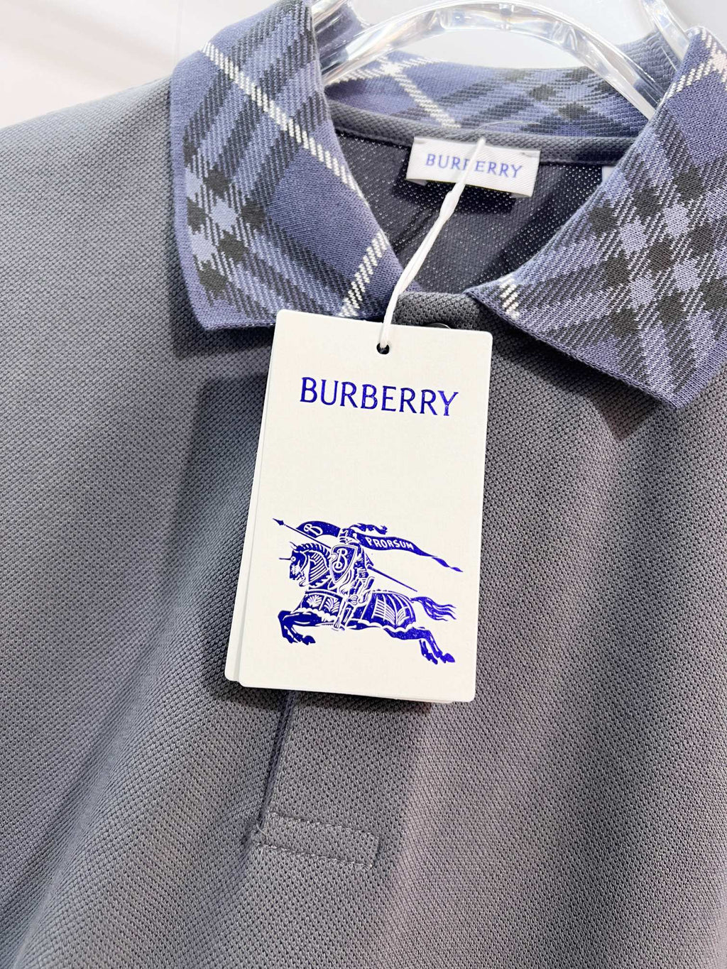 Mens polo collar and chest with plaid detail and hanging Burberry tag
