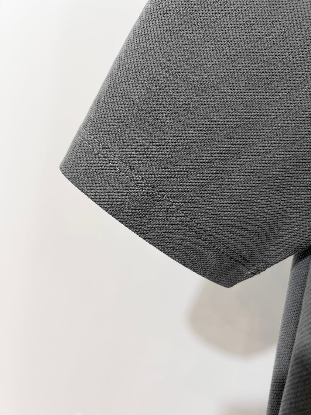 Mens short-sleeve polo shirt sleeve and hem in dark gray
