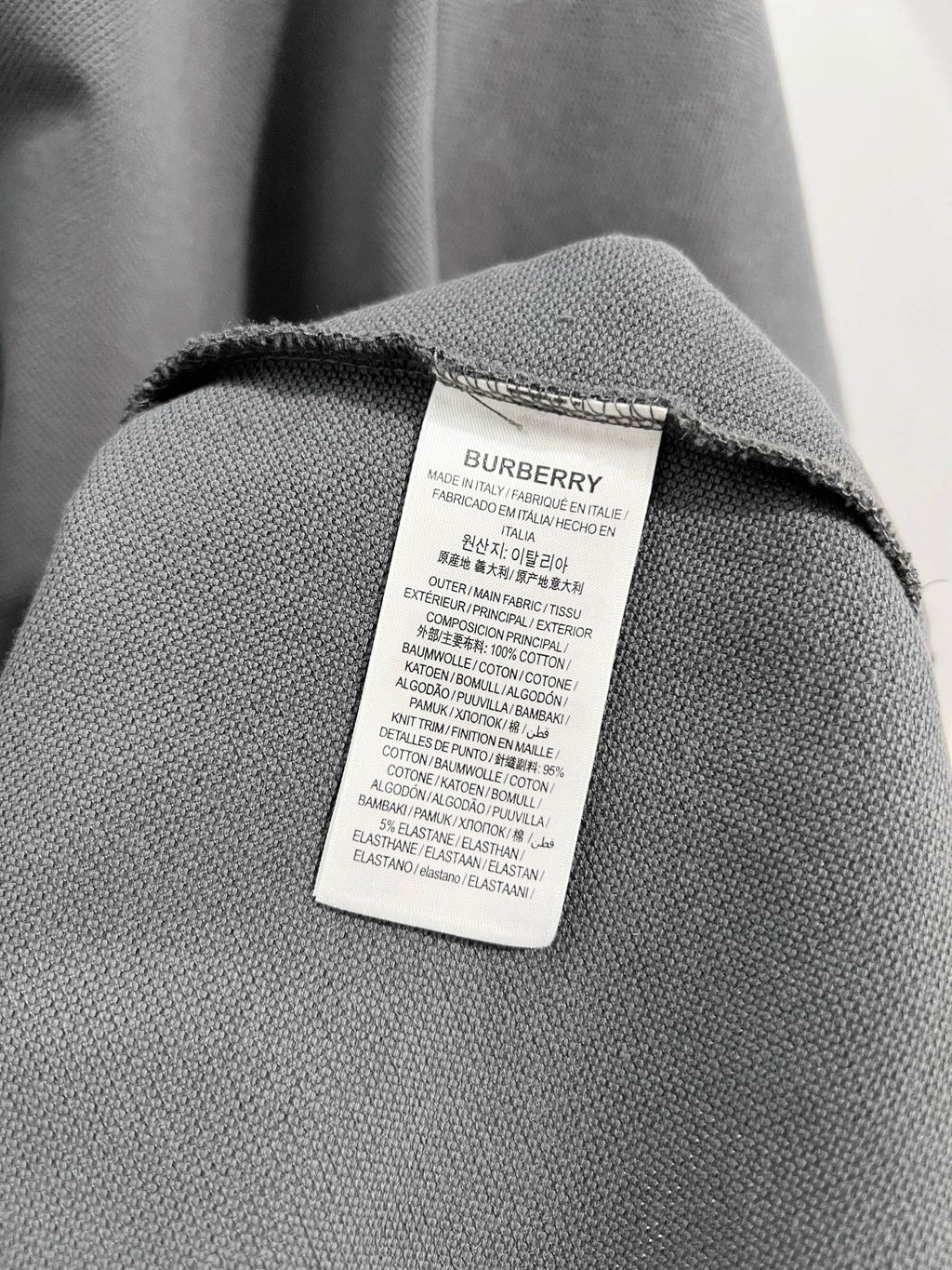 Mens polo shirt fabric with care label inside neck seam