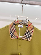 Olive green polo shirt with plaid check collar and button placket, close-up