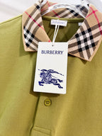 Olive green polo shirt close-up with plaid check collar and round gold buttons