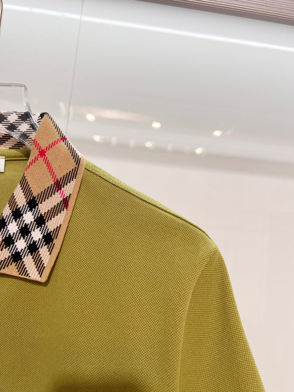 Olive green polo shirt sleeve and shoulder detail
