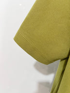 Olive green polo shirt sleeve hem detail
