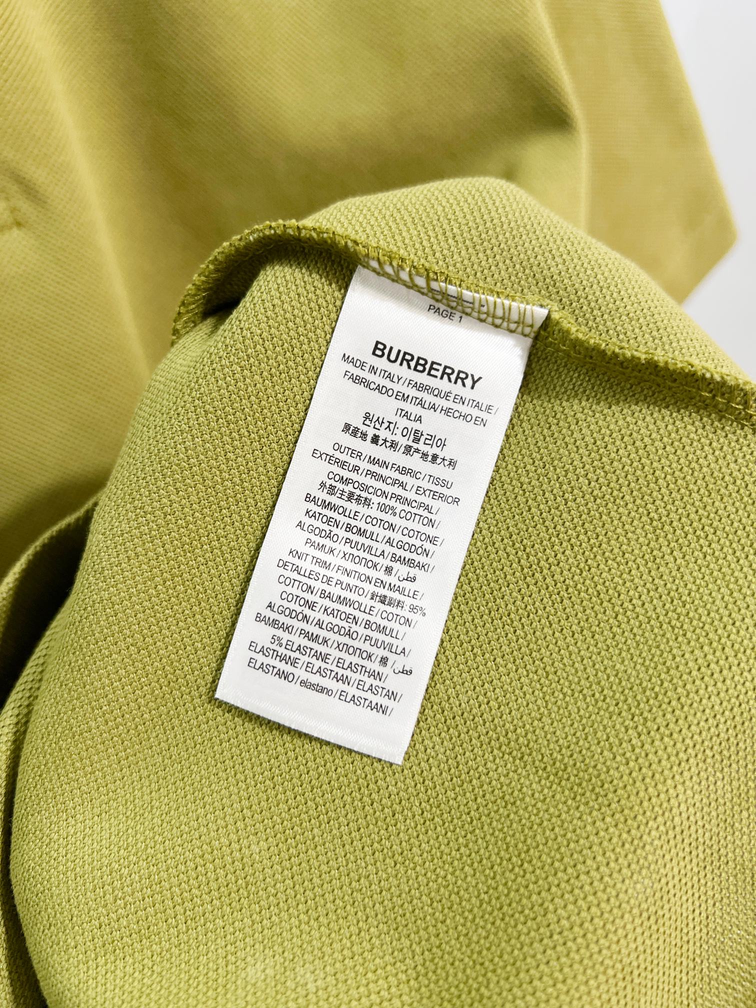 Olive green polo shirt fabric tag label on inner neck seam