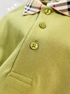 Olive green polo shirt close-up showing textured fabric and round gold buttons