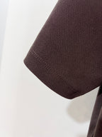 Burberry polo shirt sleeve and hem in dark brown textured fabric